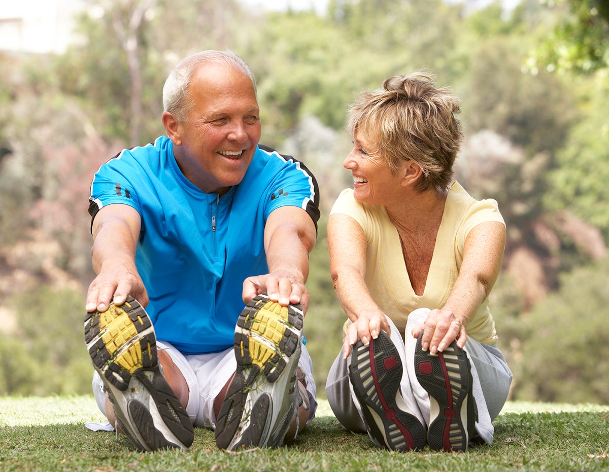 Senior Couple Exercising In Park